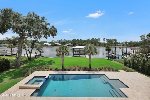 view of pool featuring an in ground hot tub, a water view, and a yard