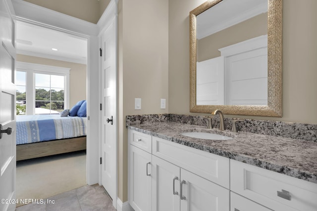 bathroom with crown molding, tile patterned floors, and vanity