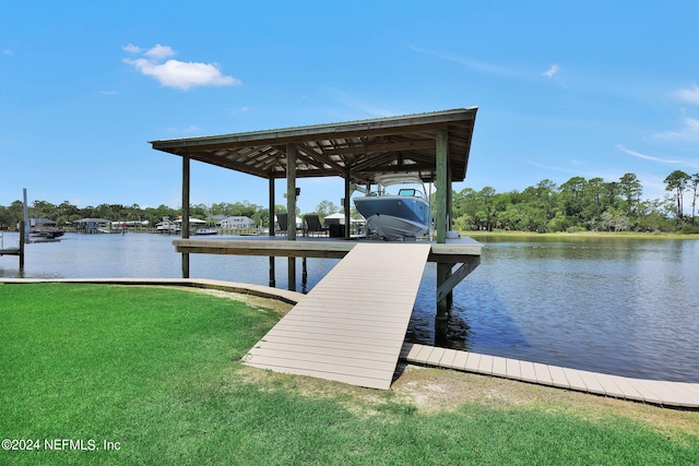 view of dock featuring a water view and a yard