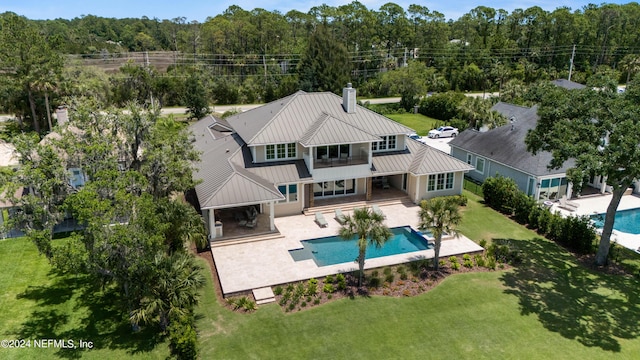 view of pool featuring a yard and a patio