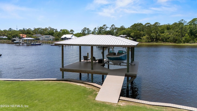 dock area with a yard and a water view