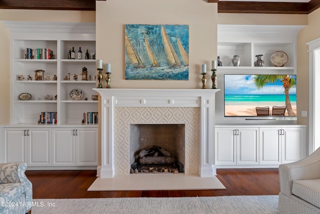 living room with dark hardwood / wood-style floors and a fireplace