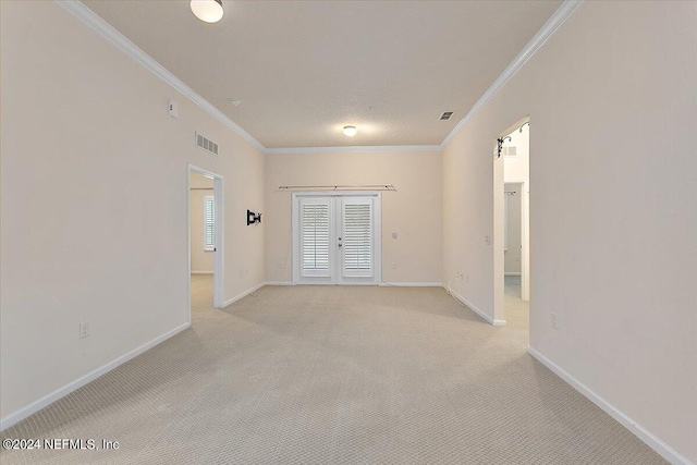 carpeted spare room featuring ornamental molding