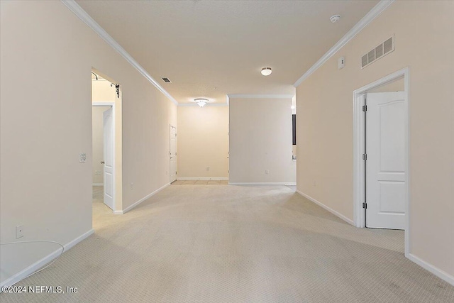 unfurnished room featuring light colored carpet and ornamental molding