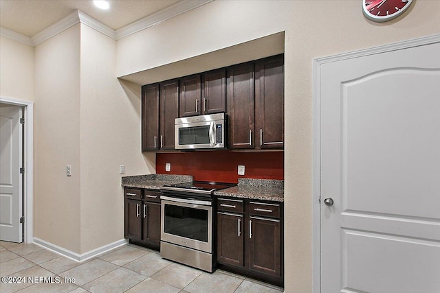 kitchen with dark stone countertops, light tile patterned floors, crown molding, appliances with stainless steel finishes, and dark brown cabinets