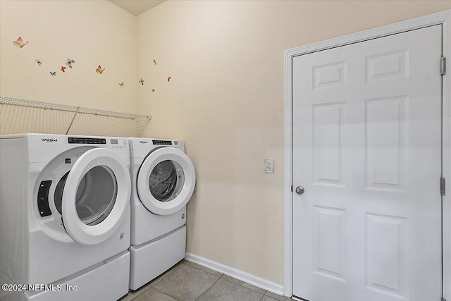 laundry room with independent washer and dryer and light tile patterned flooring