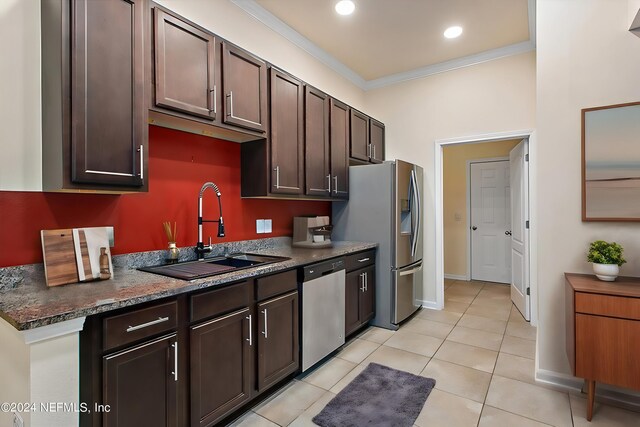 kitchen featuring ornamental molding, dark brown cabinets, sink, appliances with stainless steel finishes, and light tile patterned flooring