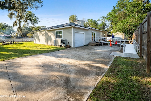 view of property exterior featuring a yard and a garage