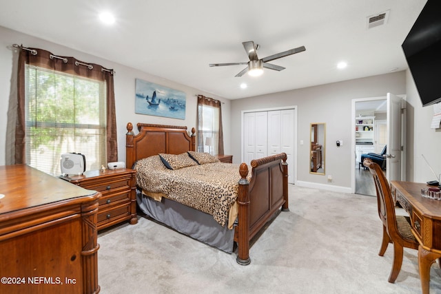 carpeted bedroom featuring a closet and ceiling fan