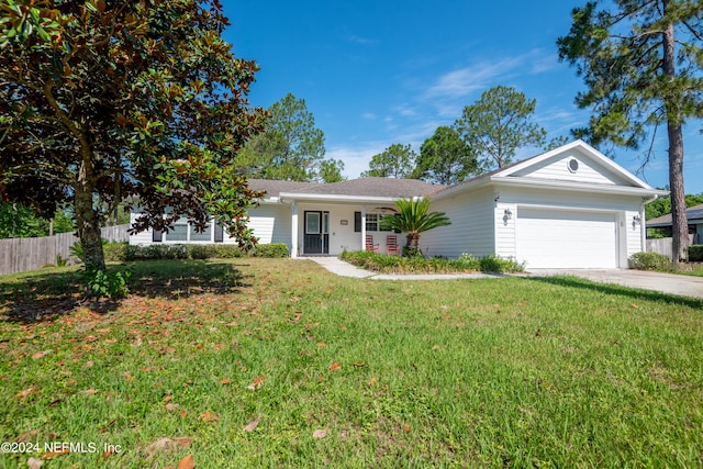 ranch-style home with a garage and a front lawn