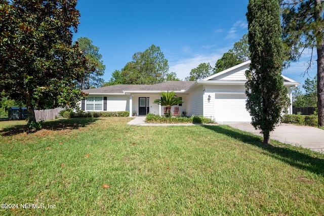 ranch-style home with a garage and a front yard