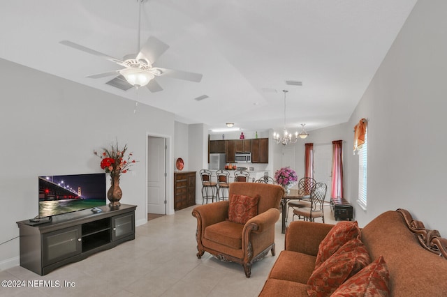 living room with ceiling fan with notable chandelier and light tile floors