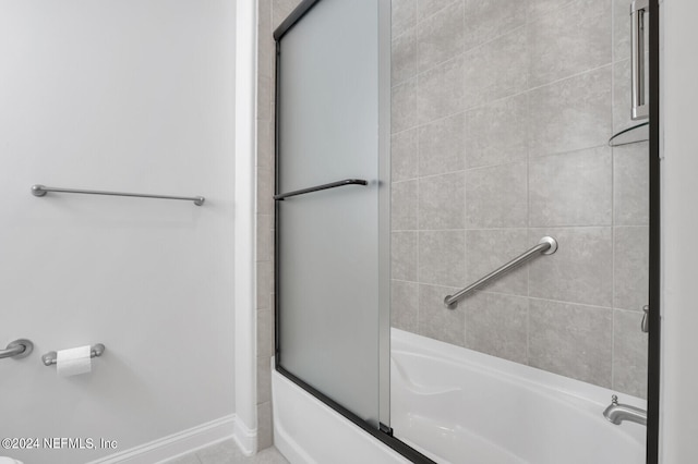 bathroom with tile floors and combined bath / shower with glass door