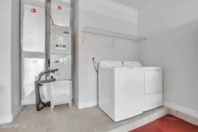 clothes washing area featuring heating utilities and independent washer and dryer