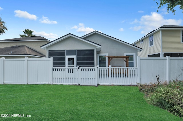 back of property featuring a lawn