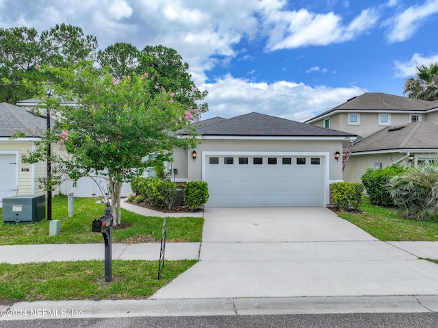 view of front of property with a front lawn and a garage