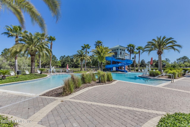 view of swimming pool with a water slide