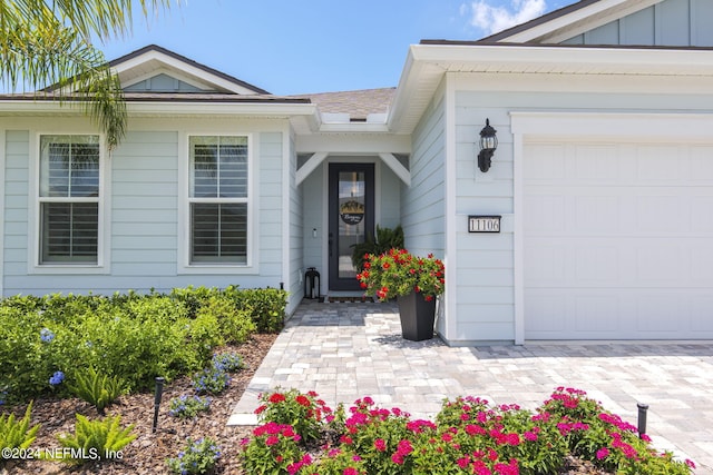 view of exterior entry featuring a garage