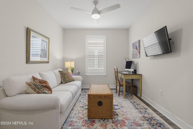 living room featuring ceiling fan and hardwood / wood-style floors