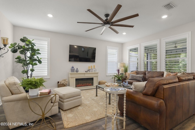 living room featuring ceiling fan and hardwood / wood-style flooring