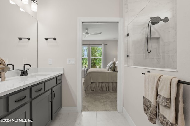 bathroom with tiled shower, tile flooring, vanity, and ceiling fan