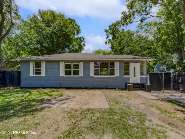 ranch-style home with a front yard and a patio