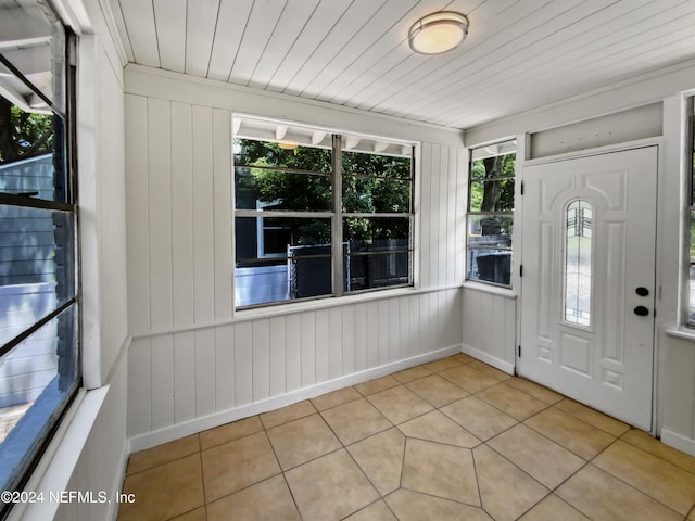 entrance foyer with wooden ceiling, plenty of natural light, and light tile flooring