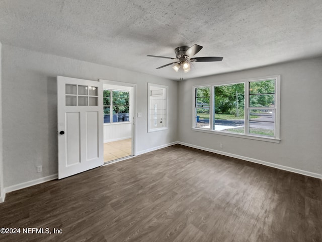 unfurnished bedroom featuring a textured ceiling, multiple windows, and ceiling fan