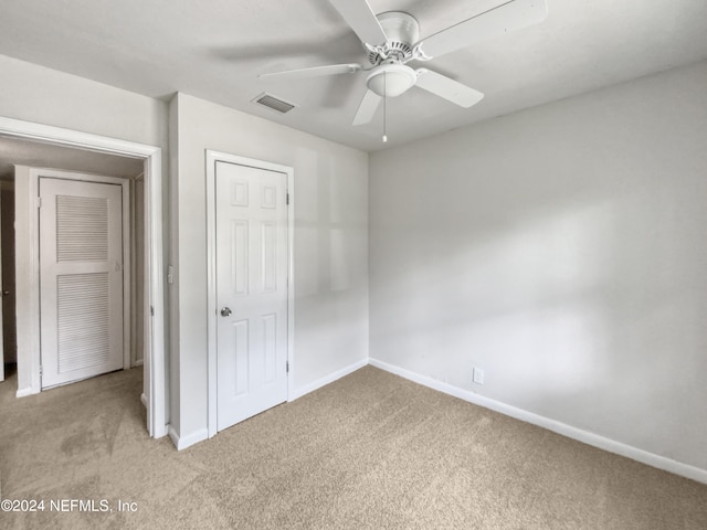 unfurnished bedroom featuring carpet flooring, a closet, and ceiling fan