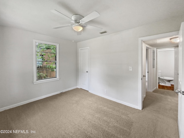 unfurnished room featuring ceiling fan and carpet floors