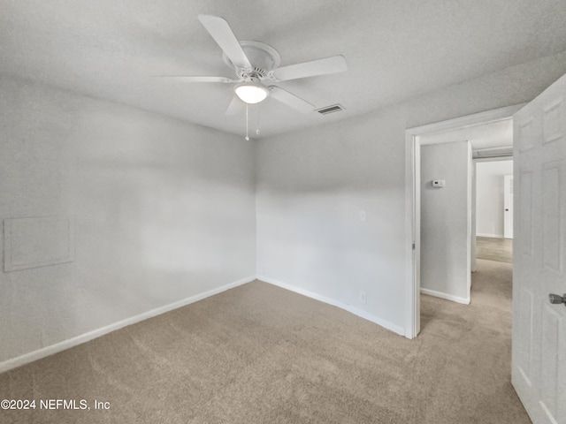 empty room with carpet flooring and ceiling fan