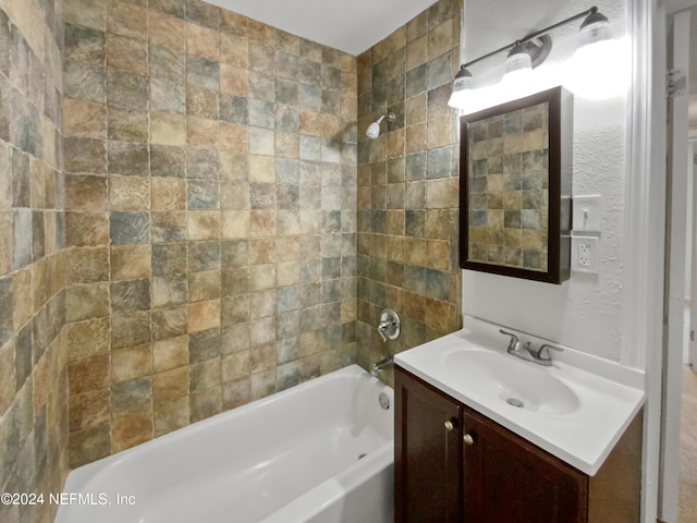 bathroom with vanity and tiled shower / bath combo