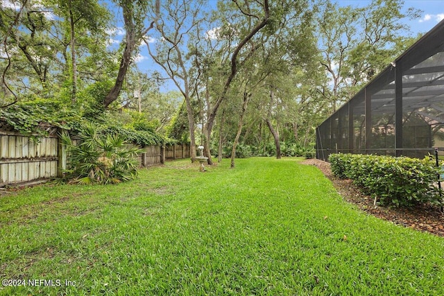 view of yard with glass enclosure