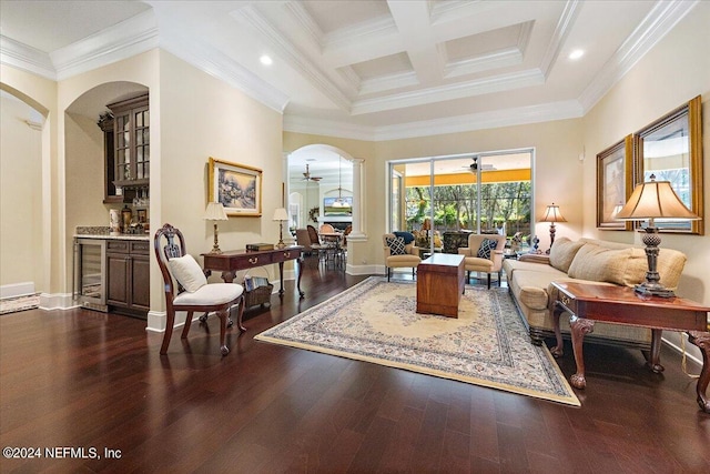 living room featuring dark wood-type flooring, coffered ceiling, ceiling fan, and crown molding