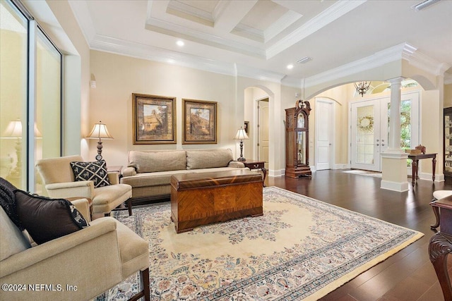 living room featuring dark hardwood / wood-style flooring, ornamental molding, decorative columns, and coffered ceiling