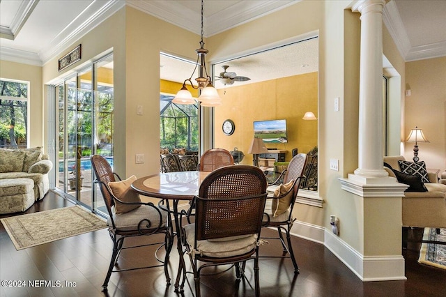 dining space featuring crown molding, decorative columns, ceiling fan, and dark hardwood / wood-style flooring