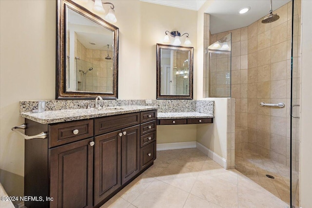 bathroom featuring ornamental molding, tile flooring, vanity, and a shower with door