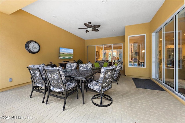 dining space with ceiling fan and a textured ceiling