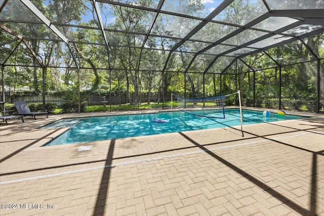 view of pool with a patio and glass enclosure