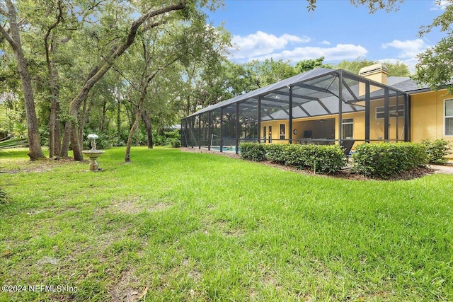 view of yard with glass enclosure