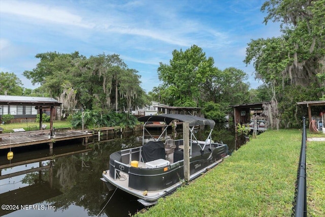 dock area with a water view and a yard