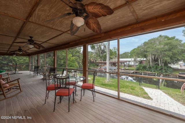 sunroom / solarium featuring wooden ceiling and ceiling fan