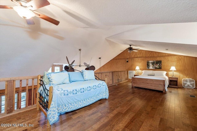 bedroom with wood-type flooring, wooden walls, ceiling fan, and lofted ceiling