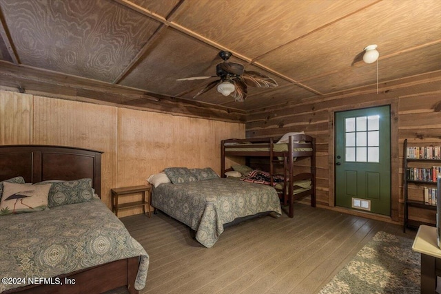 bedroom featuring wood ceiling, wood-type flooring, ceiling fan, and wood walls