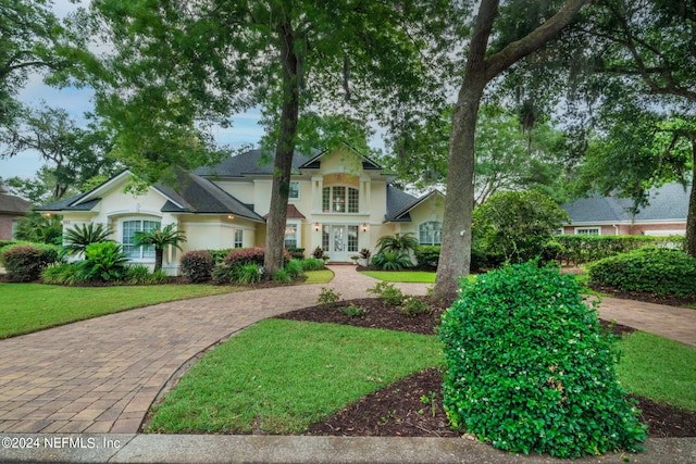 view of front of home with a front yard and french doors