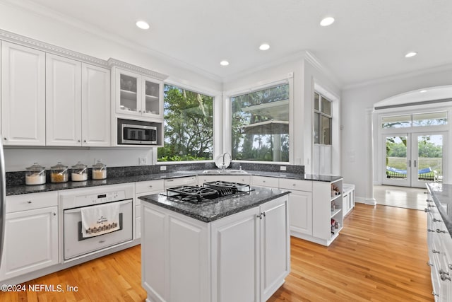 kitchen featuring stainless steel appliances, a center island, and white cabinets