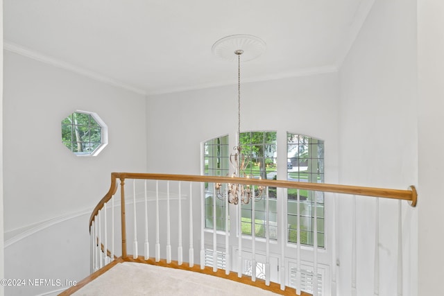 staircase featuring a notable chandelier and crown molding