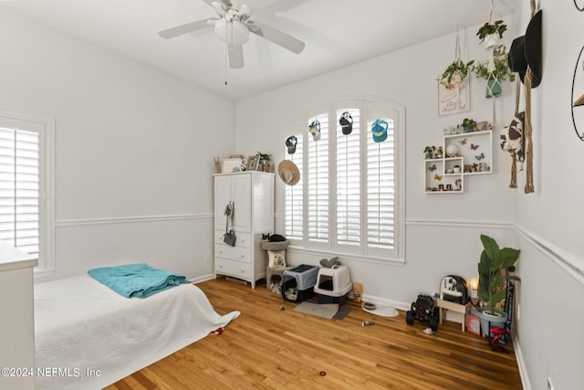 bedroom with ceiling fan and wood-type flooring