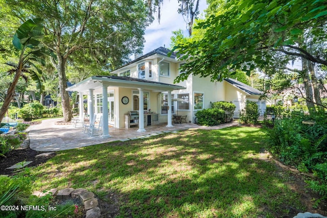 exterior space with a patio and a lawn