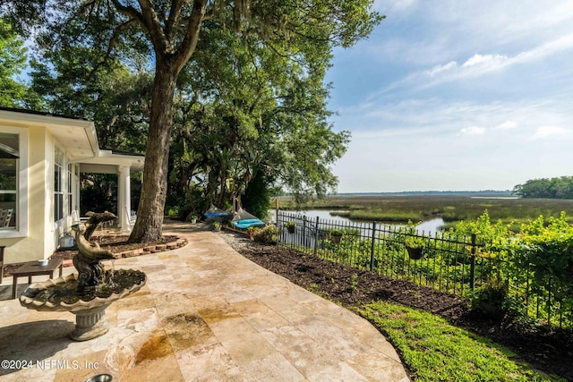 view of patio with a water view